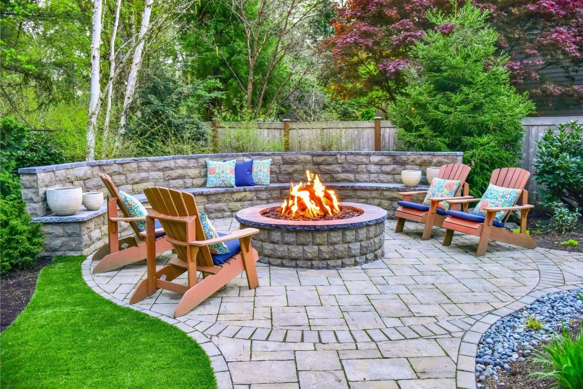 Fire pit made of pavers and chairs around it