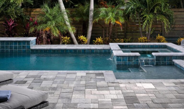 Pool deck Pavers completed next to a pool and a chair